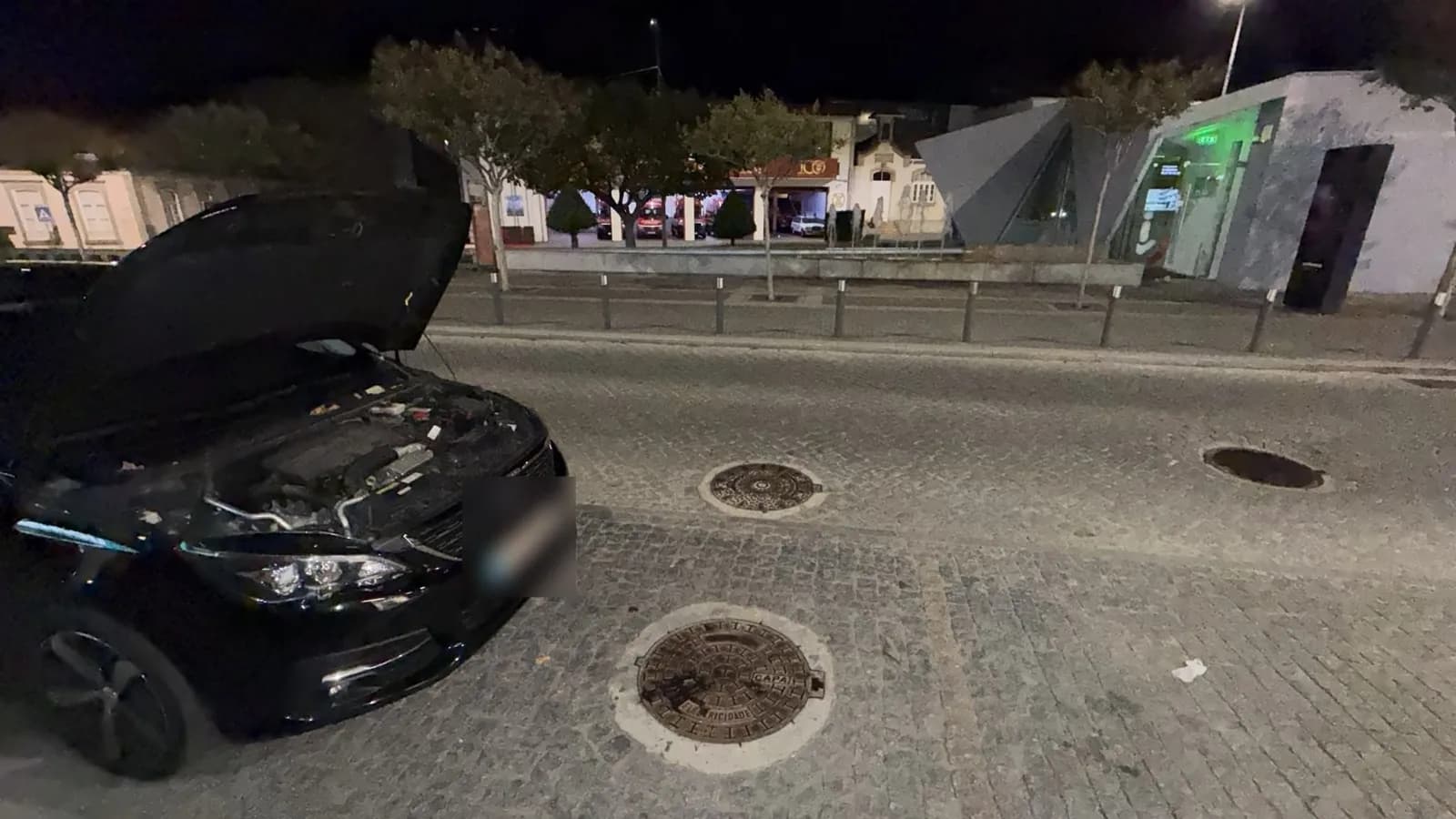 Car with the bonnet open on a street at night during a call-out