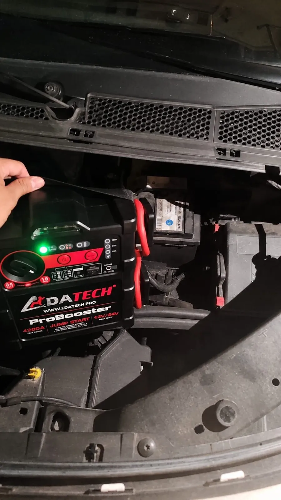 Professional booster connected to a car battery